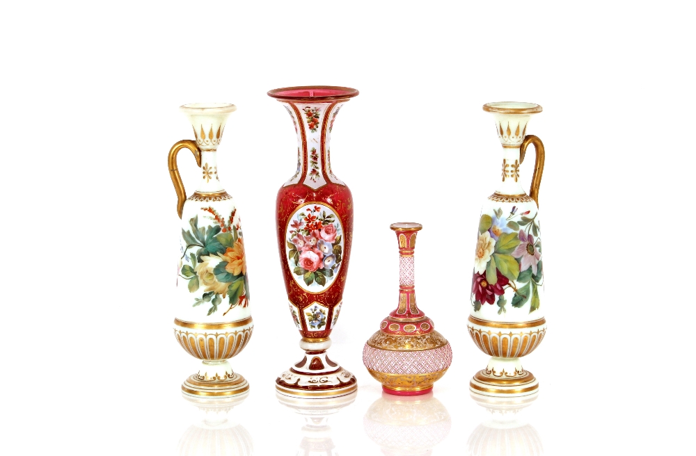 A 19th Century ruby and overlaid glass baluster vase, with profuse floral decoration, 29cm high; a