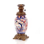 A Japanese Imari baluster oil lamp, having gilded metal mounts, 41cm high overall