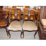 A pair of Edwardian inlaid bedroom chairs, raised on cabriole supports