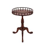 A mahogany occasional table, with circular gallery top raised on leaf carved baluster column and