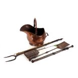 A copper coal helmet, and various iron and brass fire implements including a log fork