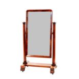 A Victorian mahogany cheval mirror, the plate raised on octagonal tapering columns and inverted