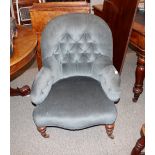 A Victorian button back nursing chair, with serpentine seat raised on turned tapering supports