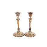 A pair of George V silver baluster candlesticks, raised on circular reeded loaded bases, 26cm