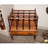 A Victorian rosewood four division Canterbury, fitted with single drawer raised on turned supports