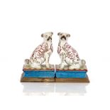 A pair of continental porcelain pug dogs, raised on brass plinth bases, 19cm high