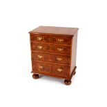 A walnut oyster veneered chest, of two short and three long graduated drawers, raised on bun feet,