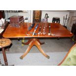 A Regency mahogany supper table, the rectangular top raised on a turned column and reeded