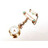 A ladies lapel watch in two colour gold, chip diamond inset decoration to the back, hung to a