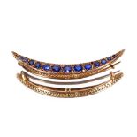 A 9ct gold sapphire set crescent brooch