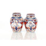 A pair of Japanese Imari patterned ginger jars and covers, with inner lids surmounted by bamboo
