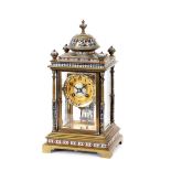 A 19th Century brass and enamel four glass mantel clock, the temple shaped case supporting a
