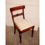 A set of four 19th Century mahogany bar back dining chairs, having upholstered drop in seats, raised