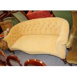 A Victorian walnut framed settee, of serpentine form, upholstered in gold button Dralon raised on