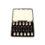 A cased set of twelve silver teaspoons, with pierced terminals, Birmingham 1925