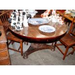 A Victorian rosewood circular snap top dining table, raised on a turned baluster column and