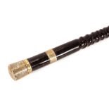 A Victorian ebonised walking stick, of tapering form having foliate engraved silver band and handle