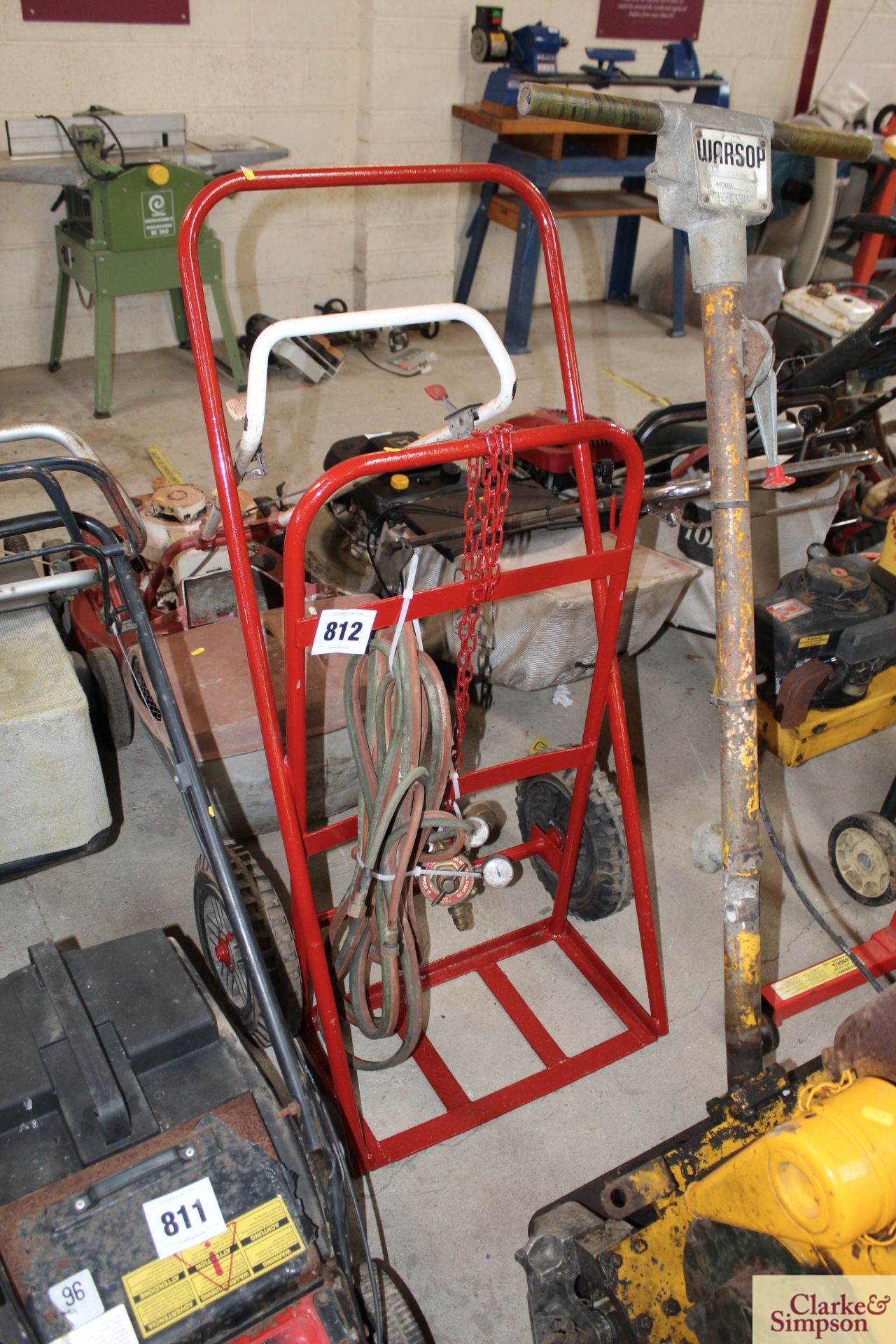 Welding trolley with hoses and gauges.