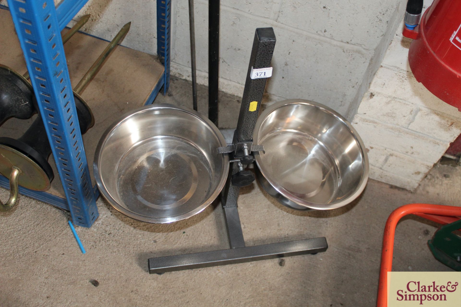 Adjustable height water and feed bowl.