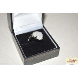 A boxed white metal and opal dress ring