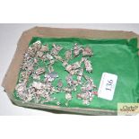 A quantity of white metal charms