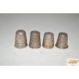 Four various silver and white metal thimbles