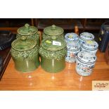Four green glazed pottery storage jars; and five m