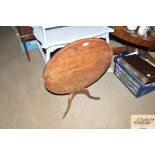 An antique elm tripod table