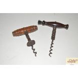 Two antique turned wooden handled corkscrews