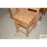 A stripped pine single drawer side table