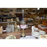 A Victorian pink glass and brass table oil lamp