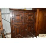 An early 20th Century oak panelled cupboard