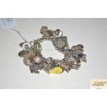 A silver and white metal charm bracelet