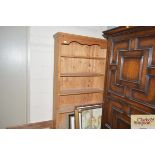 A stripped pine open fronted bookcase