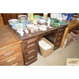 A oak pedestal desk with leatherette inset top