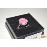 A boxed white metal pink hardstone ring