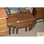 A nest of three oak occasional tables