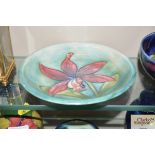 A Moorcroft burgundy 'Orchid' shallow dish with gr
