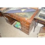 An early 20th Century oak knee hole desk with attached