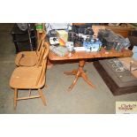 A pine drop leaf table and a pair of stick back ch