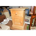 A stripped pine bedside cupboard fitted single dra