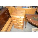 A pine bedside chest fitted four drawers