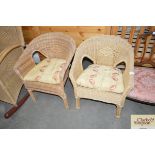 A pair of cane garden chairs with stripped cushion