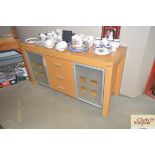 A modern beech effect sideboard fitted three drawe