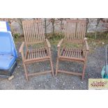 A pair of hardwood reclining garden chairs