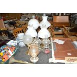 A quantity of oil lamps with milk glass shade and