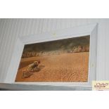 A large framed print depicting a farming scene