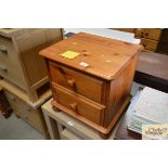 A pine bedside chest fitted two drawers