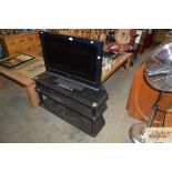 A three tier TV stand together with a Sony Bravia