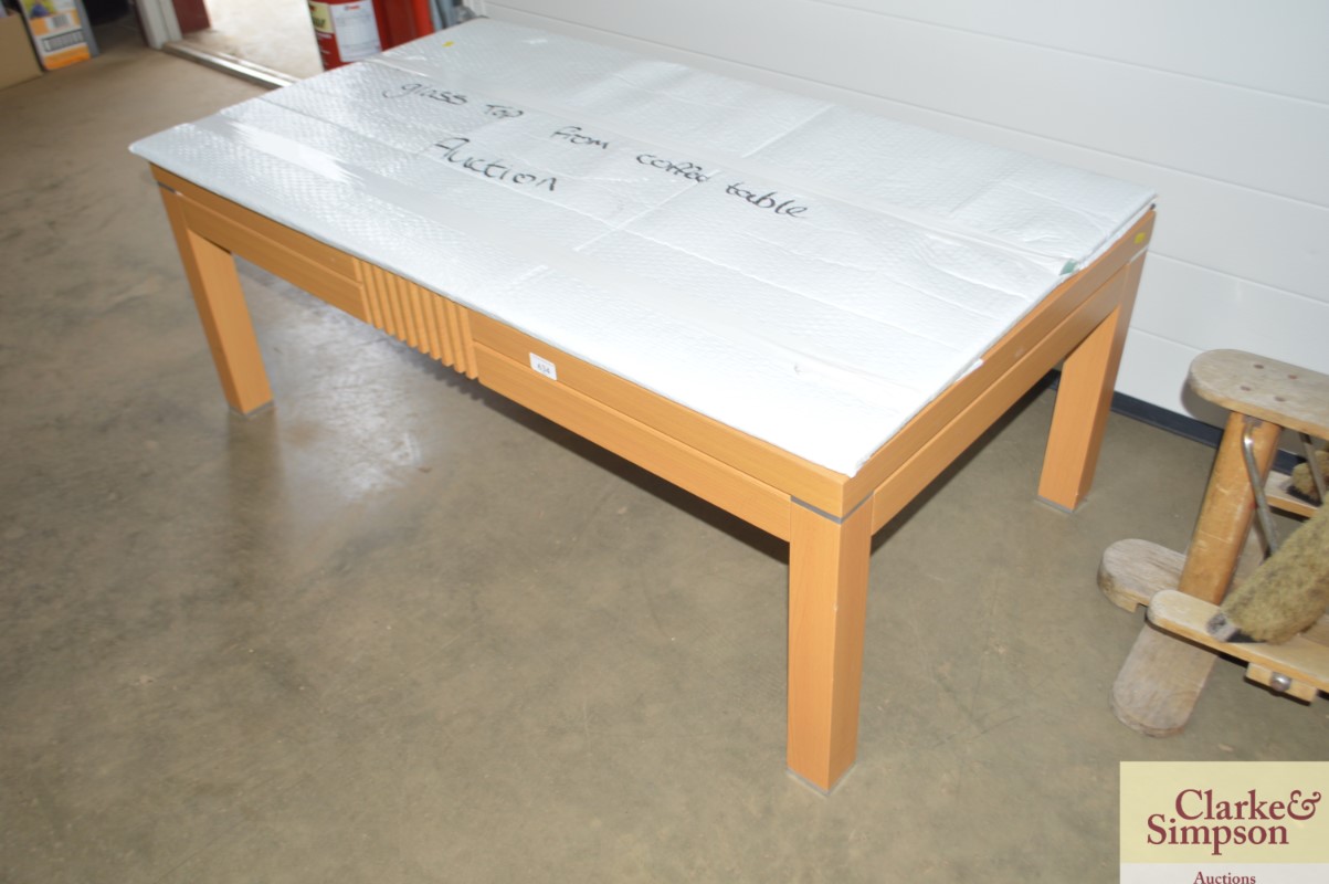 A beech effect coffee table with glass top